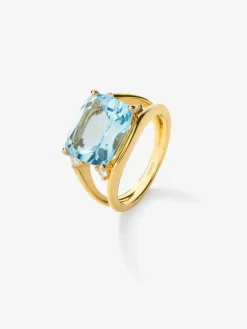 Anillo de oro amarillo de 18K con topacio azul sky en talla cushion de 7,3 cts y diamantes blancos en talla brillante de 0,13 cts