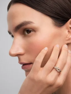 Anillo de oro amarillo de 18K con diamantes blancos en talla brillante de 0,32 cts y forma de nudo