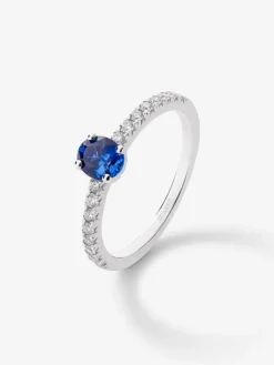 Anillo de oro blanco de 18K con zafiro oval de 0,63 cts y 16 diamantes en talla brillante con un total de 0,21 cts
