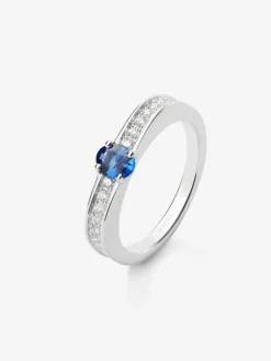 Anillo de oro blanco de 18K con zafiro azul en talla oval de 0,47 cts y 22 diamantes en talla brillante con un total de 0,16 cts