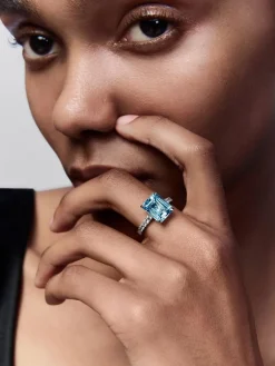 Anillo de oro blanco de 18K con topacio azul sky en talla esmeralda de 4,25 cts y diamantes blancos en talla brillante de 0,31 cts