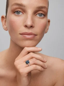 Anillo de oro blanco de 18K con topacio azul london en talla esmeralda de 4,25 cts y 14 diamantes en talla brillante con un total de 0,32 cts