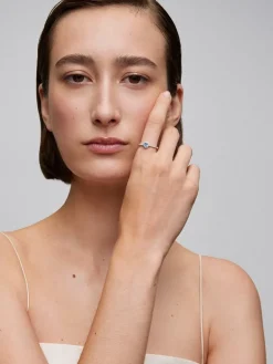 Anillo de oro blanco de 18K con zafiro azul en talla oval de 0,31 cts y 26 diamantes en talla brillante con un total de 0,216cts