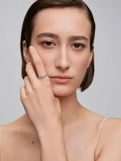 Anillo solitario de oro blanco de 18K con diamante central en talla brillante de 0,25 cts y 30 diamantes en talla brillante con un total de 0,24 cts