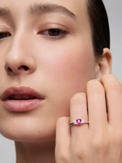 Anillo tresillo de oro blanco de 18K con rub&iacute; en talla oval de 0,45 cts y 2 diamantes en talla brillante con un total de 0,2 cts