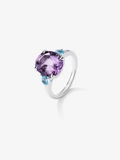 Anillo tresillo de plata 925 con amatista morada en talla oval y 2 topacios azul swiss en talla brillante