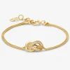 Pulsera de oro amarillo de 18K con 17 diamantes en talla brillante con un total de 0,15 cts y forma de nudo