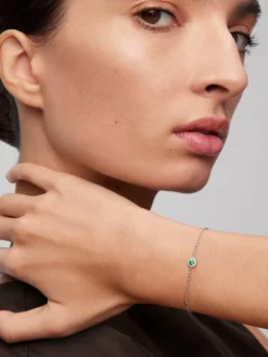 Pulsera de oro blanco de 18K con esmeralda en talla brillante de 0,1 cts y diamantes en talla brillante de 0,05 cts