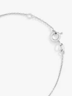 Pulsera de oro blanco de 18K con 11 diamantes en talla brillante con un total de 0,04 cts y cruz