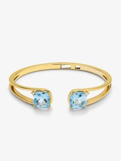 Pulsera r&iacute;gida de oro amarillo de 18K con 2 topacios azul sky en talla cushion con un total de 0,12 cts
