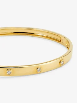 Pulsera r&iacute;gida de oro amarillo de 18K con diamantes blancos en talla brillante de 0,13 cts