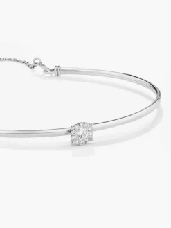 Pulsera r&iacute;gida de oro blanco de 18K con 11 diamantes en talla brillante con un total de 0,2 cts
