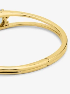 Pulsera r&iacute;gida de oro amarillo de 18K con 2 topacios azul sky en talla cushion con un total de 0,12 cts