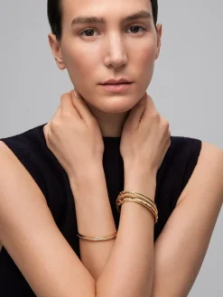 Pulsera r&iacute;gida de oro amarillo de 18K con 123 diamantes en talla brillante con un total de 0,3 cts