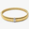 Pulsera r&iacute;gida gallonada de oro blanco y amarillo de 18K con pavé de diamantes en talla brillante con un total de 0,16 cts