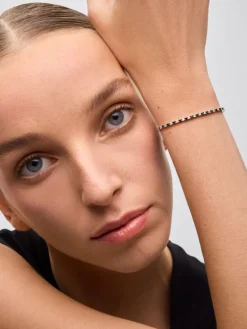 Pulsera riviere de oro blanco de 18K con diamante negro y diamante blanco