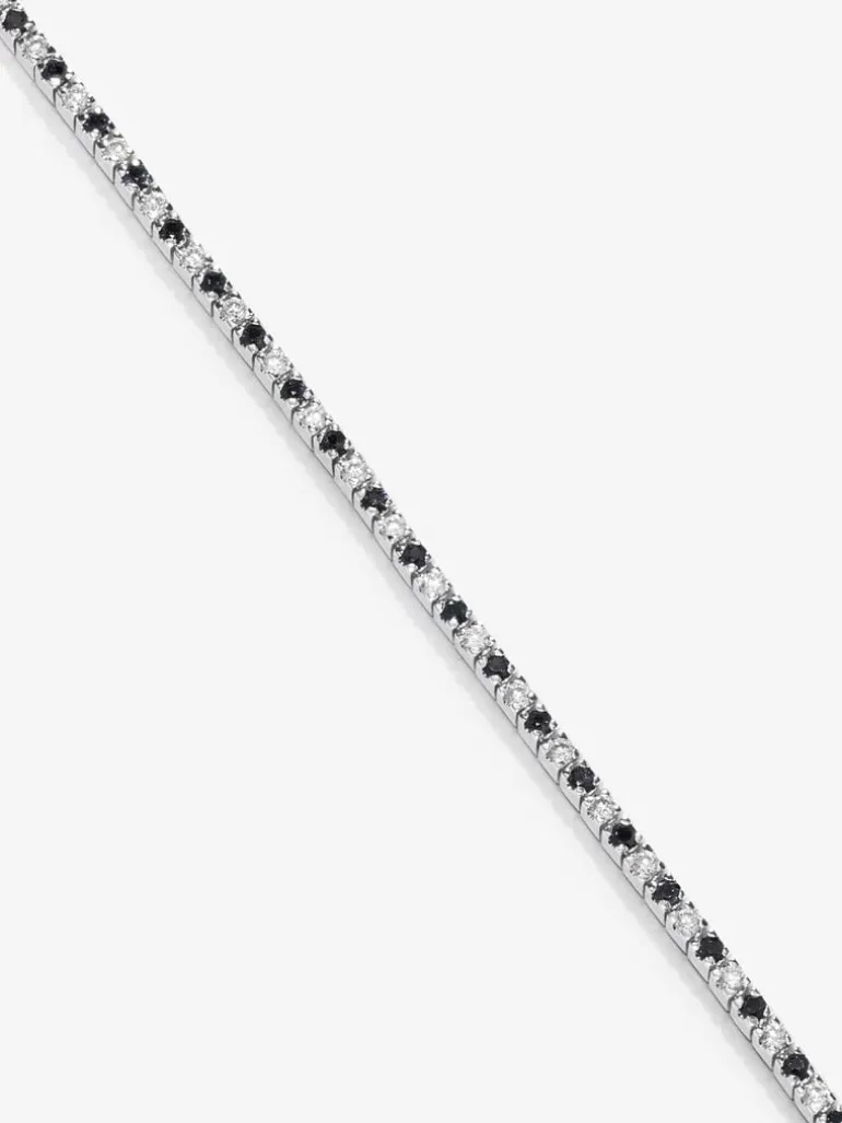 Pulsera riviere de oro blanco de 18K con diamante negro y diamante blanco