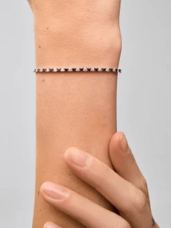 Pulsera riviere de oro blanco de 18K con diamante negro y diamante blanco